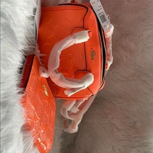 Bright orange mini Coach bag w/wallet
